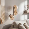 Modern Globe wall light Koyoto with three vertical amber-clear glass shades for the couch
