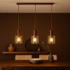 Brilliant linear pendant light Petje for kitchen island, 3 amber glass shades, 20 cm long