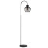Brilliant Leuchten Arched floor lamp Ligari, curved arm, smoke-glass shade beside sofa