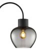 Brilliant Leuchten Arched floor lamp Ligari, curved arm, smoke-glass shade beside sofa